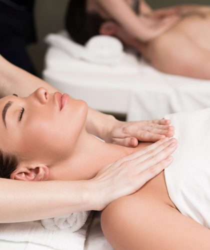 selective focus of couple having massage in spa salon